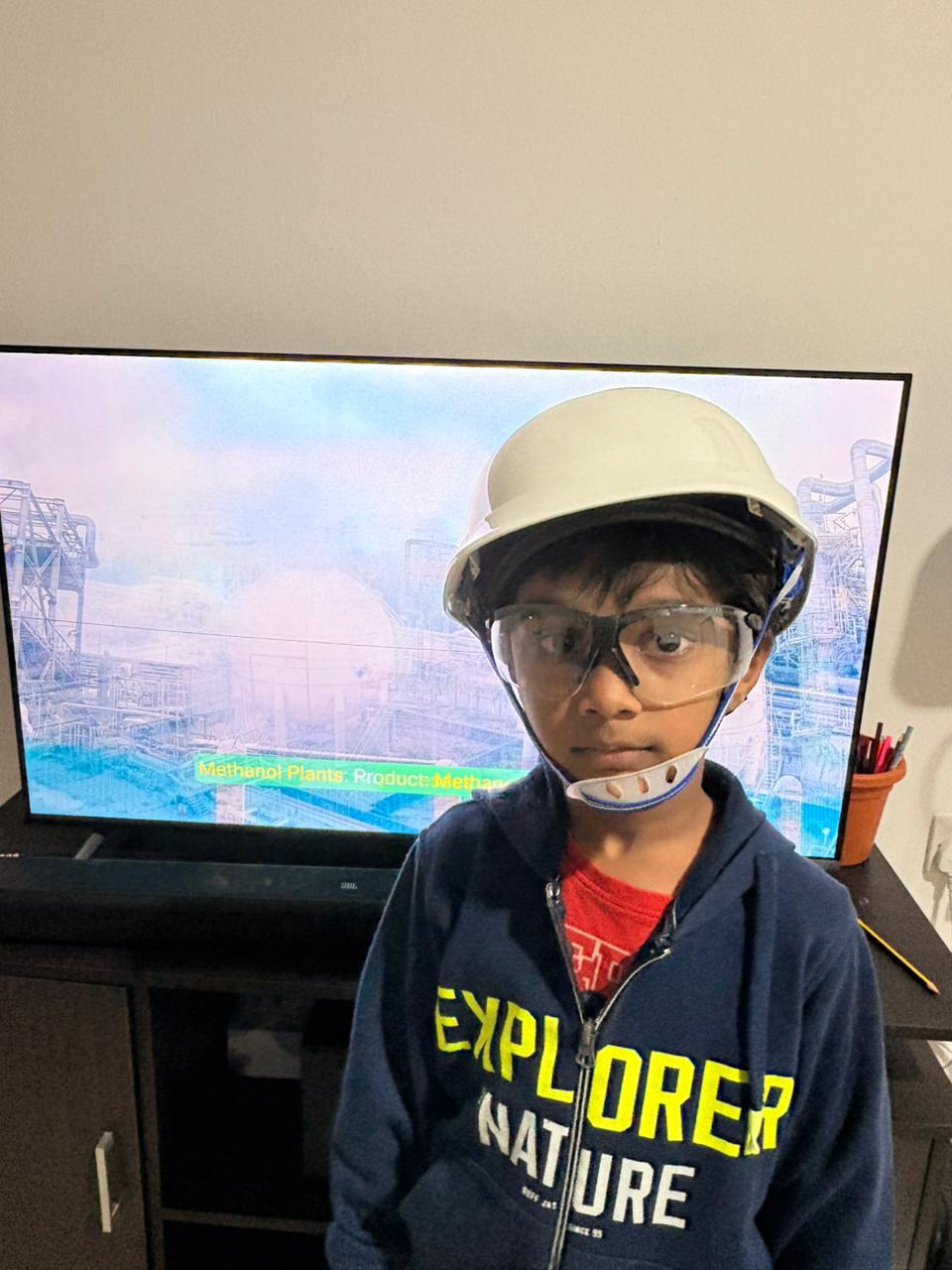 Dhyanchand wearing a hard hat and safety glasses, Explorer hoodie on
